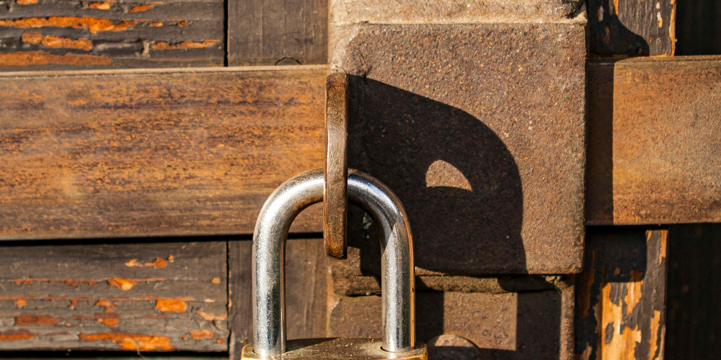 A padlock securing a wooden door, representing the protection of your personal information